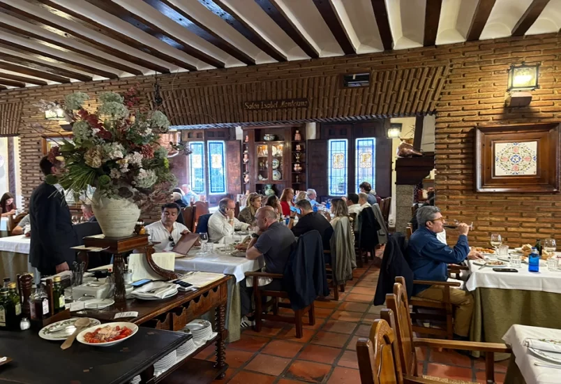 Traditional Madrid dining at Posada de la Villa includes local wines and roast suckling lamb cooked in a wood-fired oven