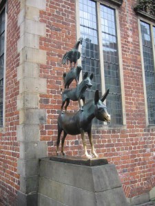 The bronze statue of the Bremen Town Musicians sits in Bremen. The fairytale about these intrepid animals was popularized by the Brothers Grimm.