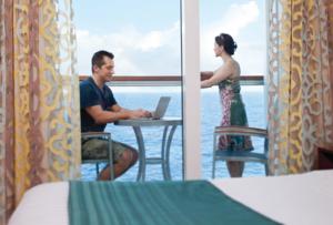 Guests using High speed Wifi on their stateroom balcony