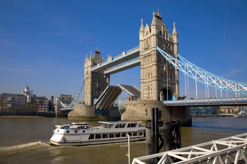 View from the riverside of Tower Bridge being raised
