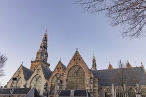 Gothic Architecture of De Oude Kerk Old Church in Amsterdam Under a Clear Sky.