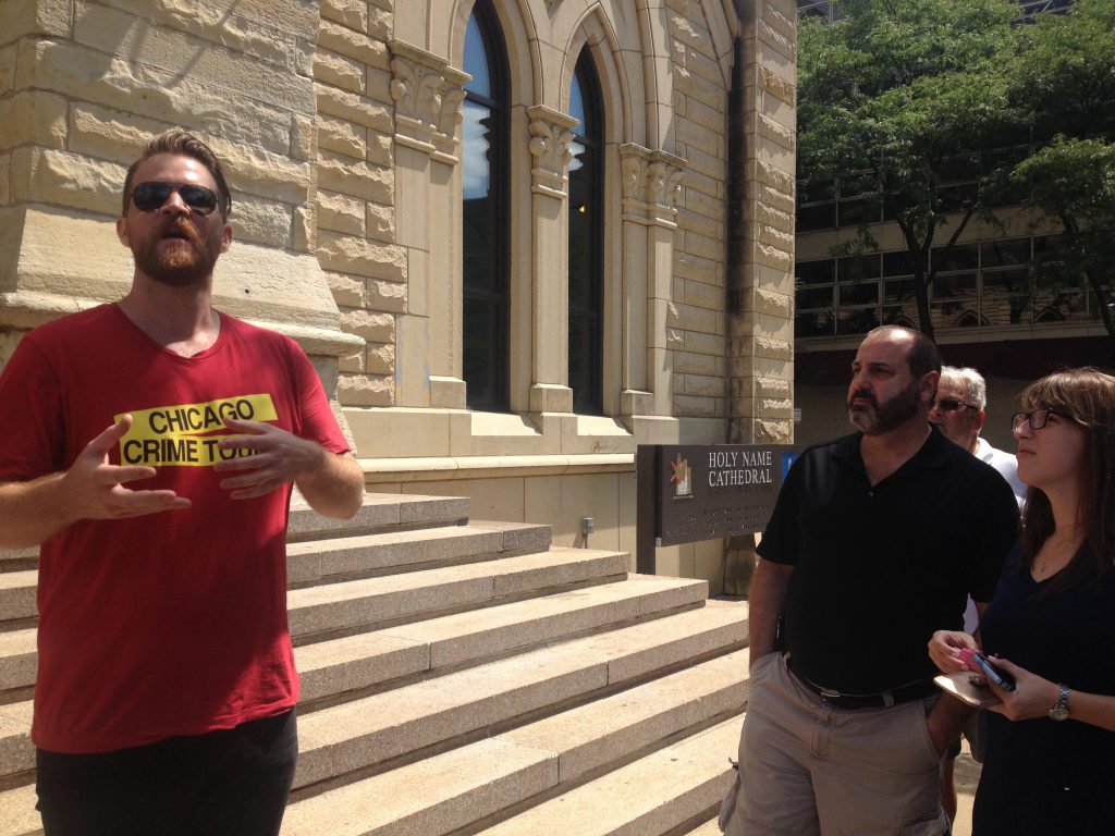 Landry explains the story behind Al Capone and Hymie Weiss’ rivalry outside Holy Name Cathedral. Photo Credit: Ally Mahoney