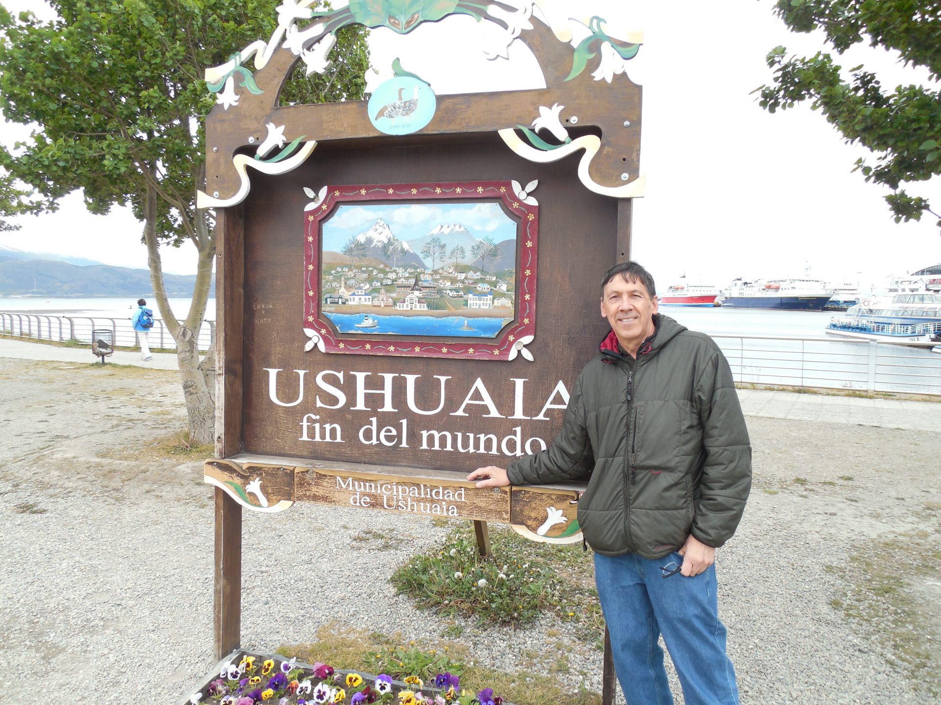 Writer Randy Mink poses at the iconic End of the World sign on the Ushuaia waterfront