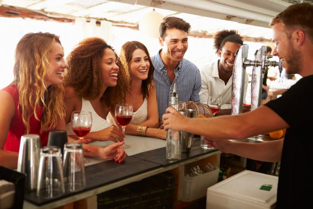 Friends Enjoying Drink At Outdoor Bar