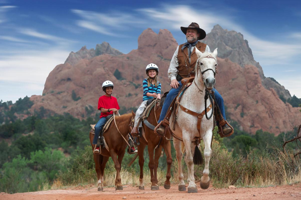 The cowboy life in the USA West as cowboys relax and talk on old