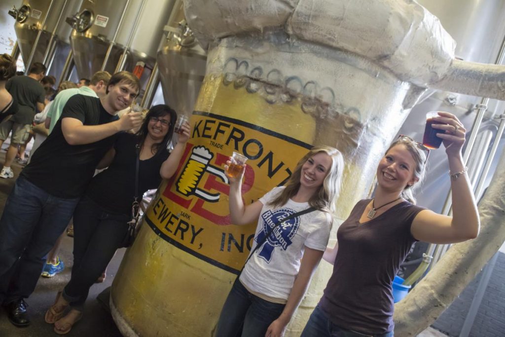 Three women and a man enjoying the Lakefront Brewery Tour.