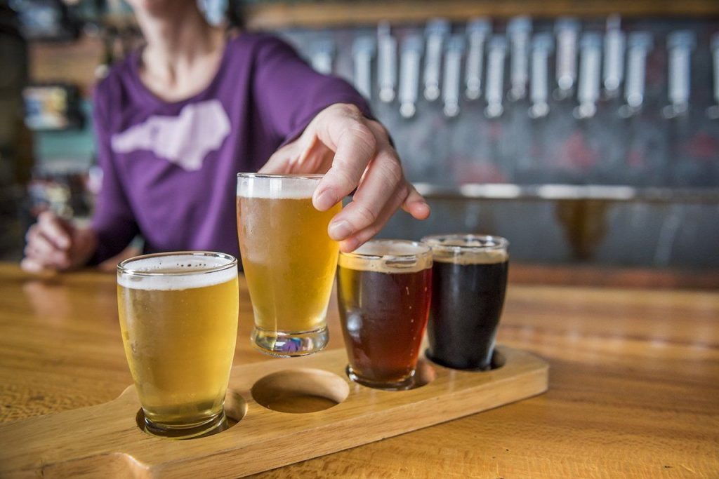 Enjoying a beer flight at Hi-Wire Brewing in Asheville’s South Slope neighborhood. (Photo credit: ExploreAsheville.com)