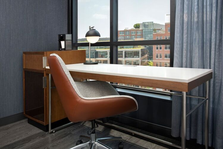 Ample desk space with an oversized roller chair and view of N Street in Washington, D.C.’s Dupont Circle neighborhood.
