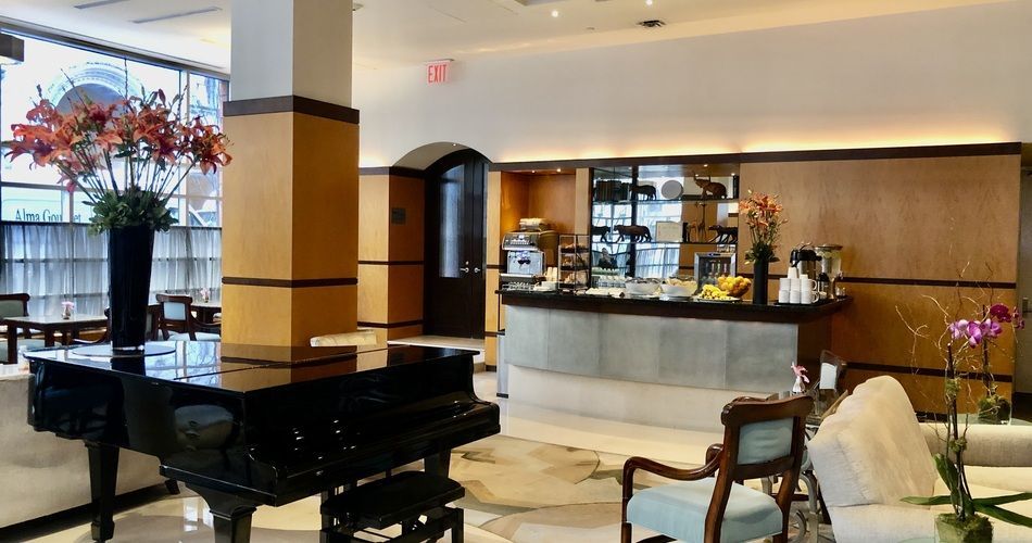 A baby grand piano sits in the middle of the Hotel Giraffe’s lobby lounge. (Photo credit: Library Hotel Collection)