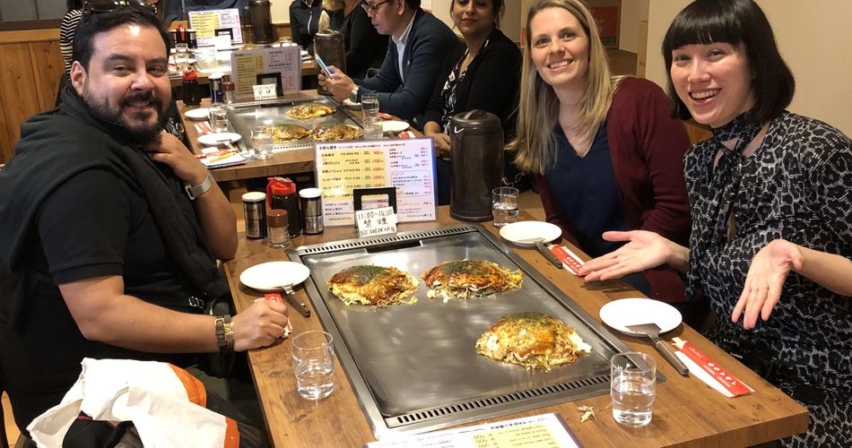 Goway travelers in Hiroshima, Japan feast on okonomiyaki, a local specialty. (Randy Mink Photo)