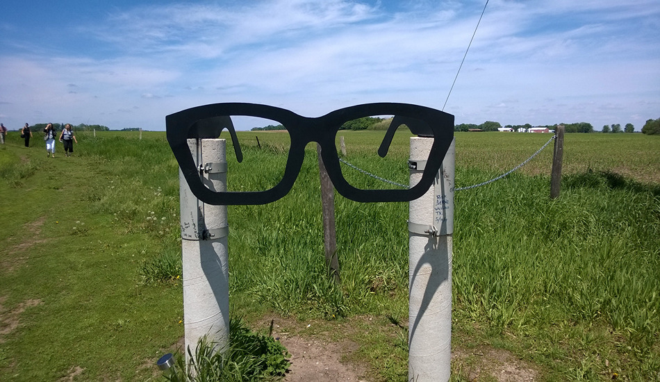 A pair of Buddy Holly’s horn-rimmed glasses lets motorists know they are near the site of the plane crash that killed Holly, Ritchie Valens, The Big Bopper and pilot Roger Peterson. (Photo credit: Clear Lake Area Chamber of Commerce)