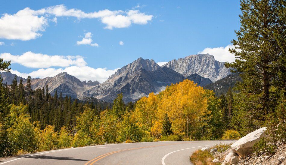 The Sierra Nevada’s granite peaks provide a dramatic backdrop for forests accented with the golden leaves of quaking aspen trees. (Photo credit:  Patrick Griley/Mammoth Lakes Tourism)