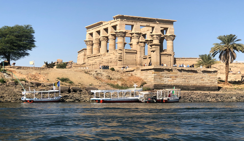 The Philae Temple Complex resides on an island in the reservoir of the Low Aswan Dam. Local motor boats shuttle Nile cruise passengers from their ship to the site.