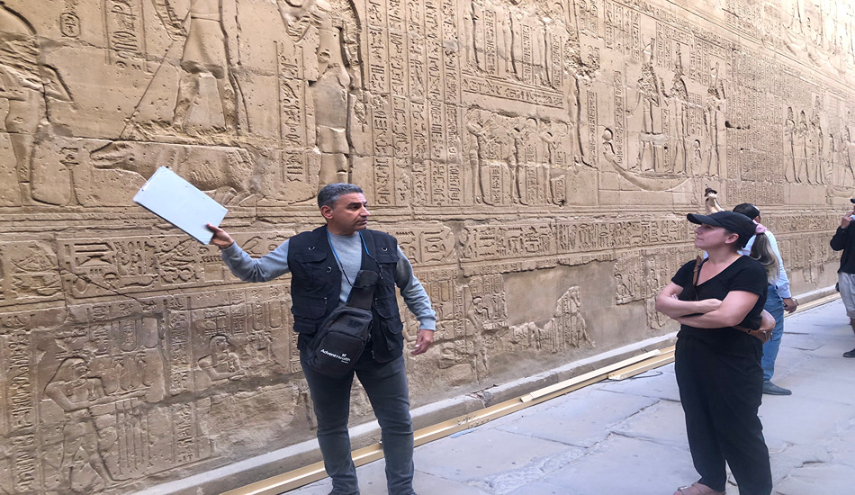 An Egyptologist guide enlightens tour members at the Temple of Edfu, which was started in 237 B.C. and finished 180 years later.
