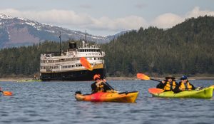 Guests of UnCruise Adventures’ 86-passenger Wilderness Legacy paddle off the pristine coast of Southeast Alaska.