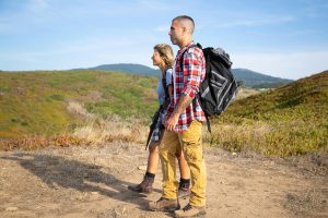 https://www.pexels.com/photo/couple-walking-together-along-a-field-road-5937240/