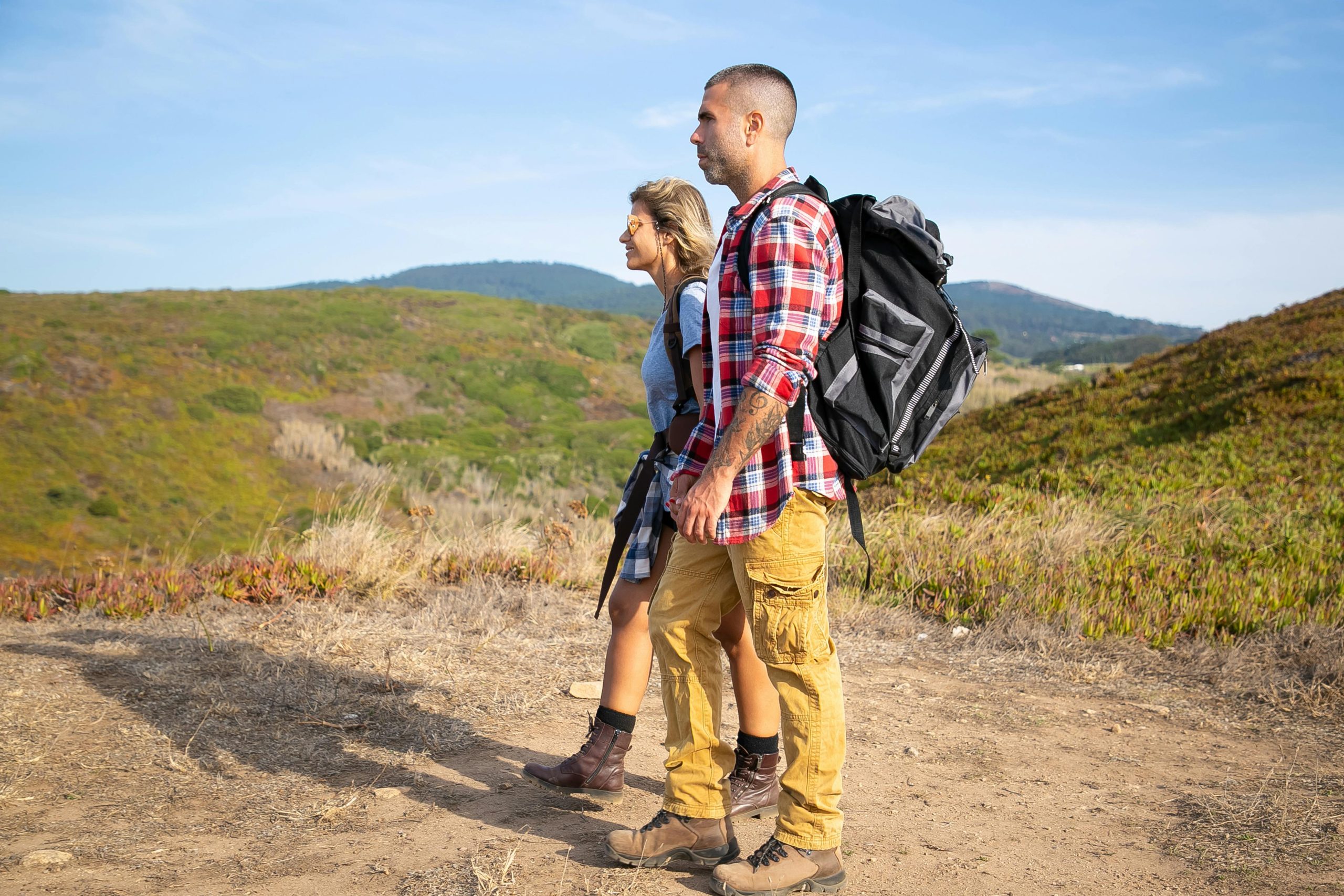 https://www.pexels.com/photo/couple-walking-together-along-a-field-road-5937240/