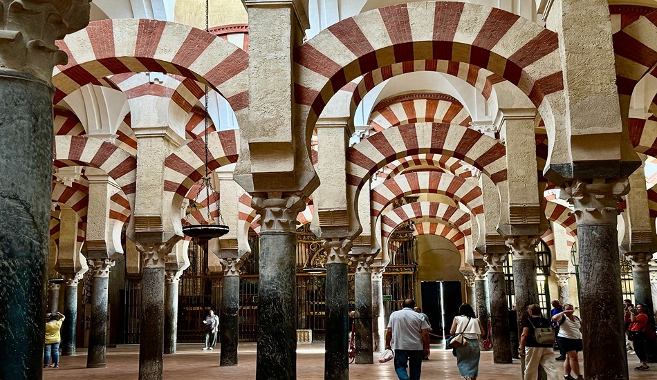 An endless forest of columns and arches mesmerizes visitors to the Mezquita, a mosque turned church. It is Cordoba's most important tourist sight.